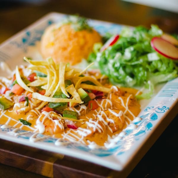 ZOCALO's shrimp dish with avocado, tomatoes, tortilla strips, rice, and a side salad.